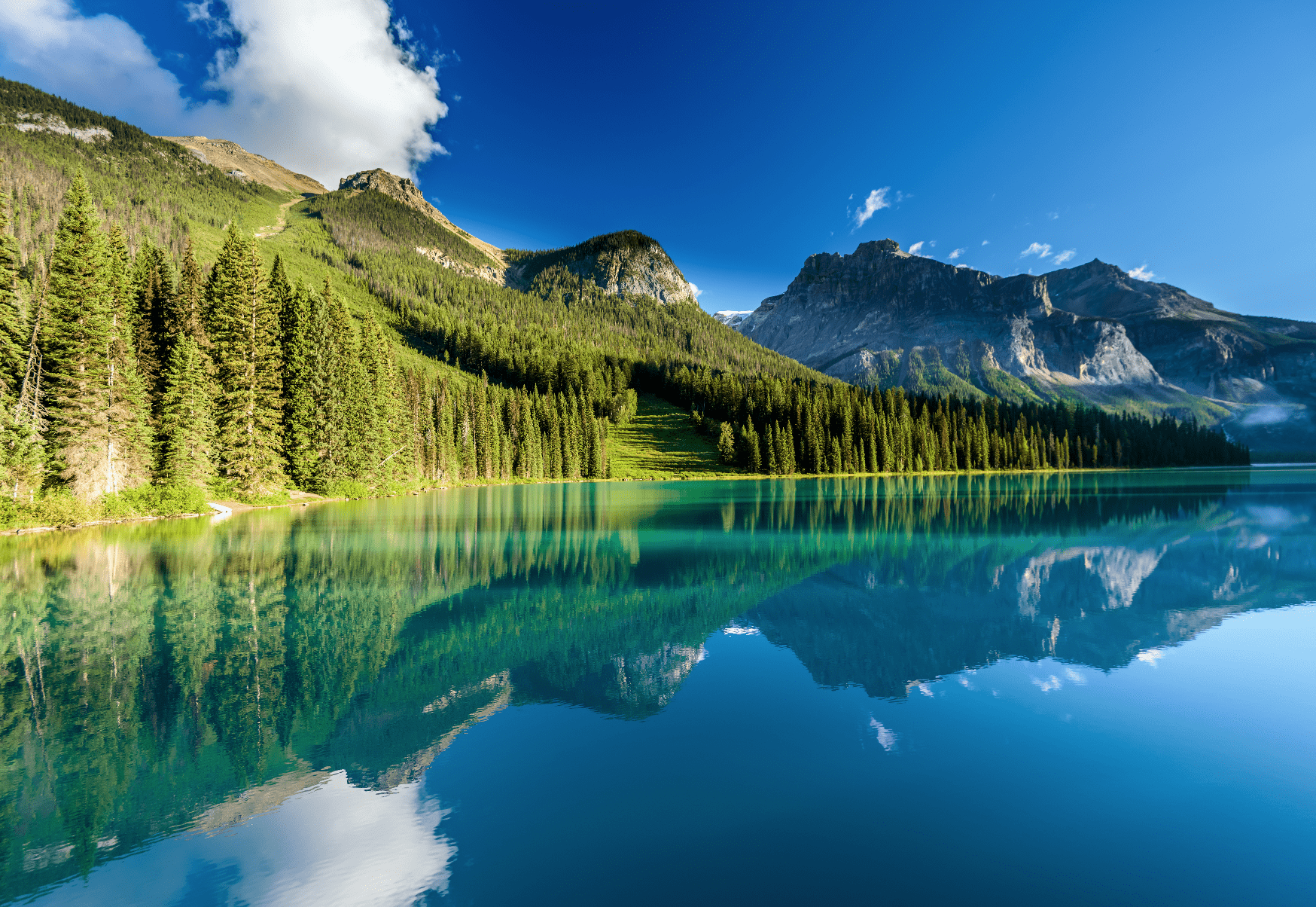 a landscape of a mountain next to a lake